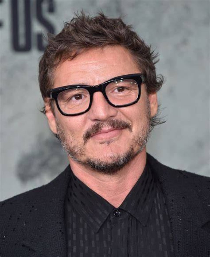 Pedro Pascal wearing glasses and a white button-down as he accepts an award at the 2024 SAG Awards
